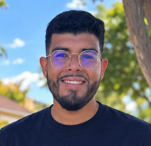Brai smiling outdoors on a sunny day
